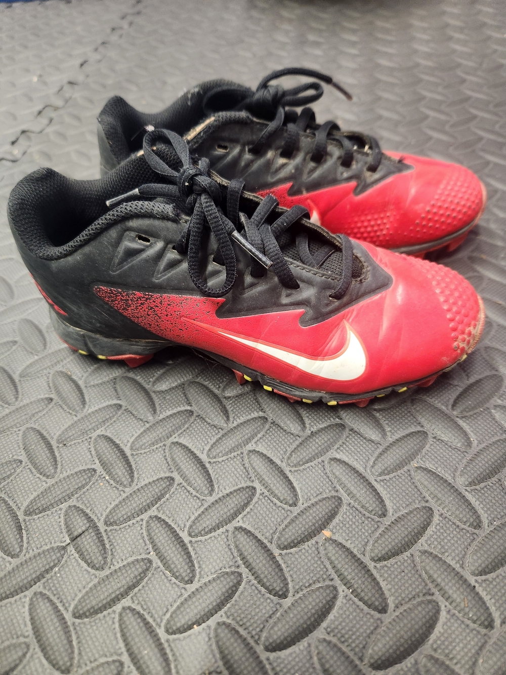Nike Kids Red and Black Cleats with White Swoosh